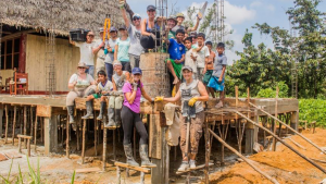 image of guests and locals building a new classroom