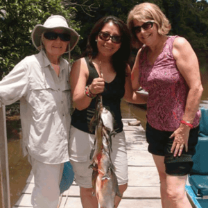 Three guests showing piranha catch for the day