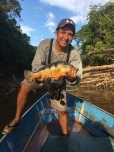 photo of guest holding peacock bass caught while staying at Amazonia Expedition's Tahuayo Lodge