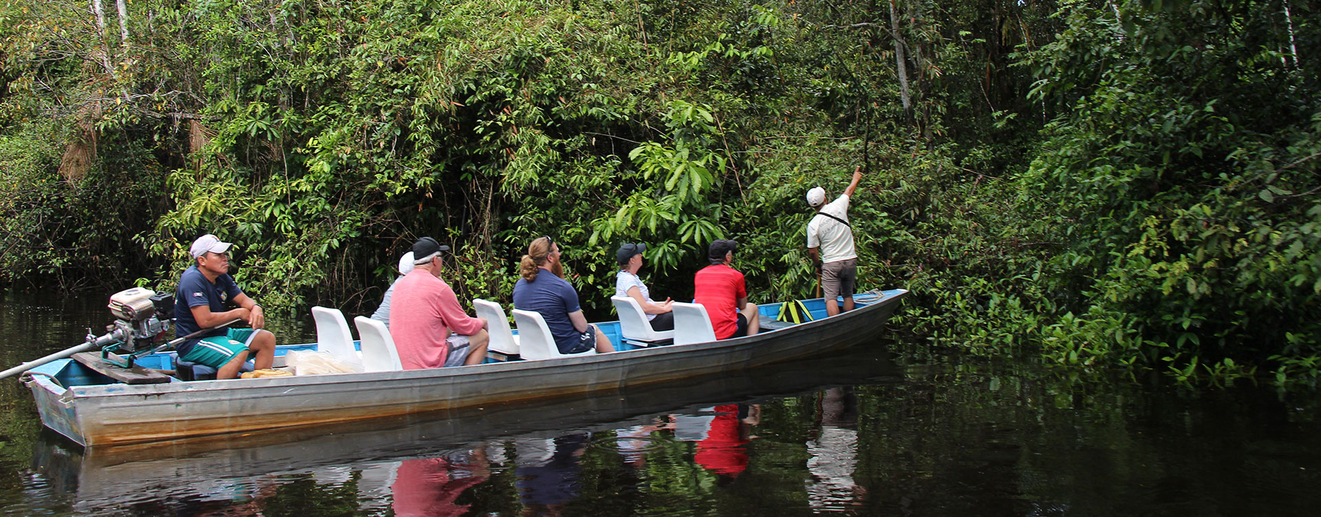 amazonia expeditions guide with tourists in boat